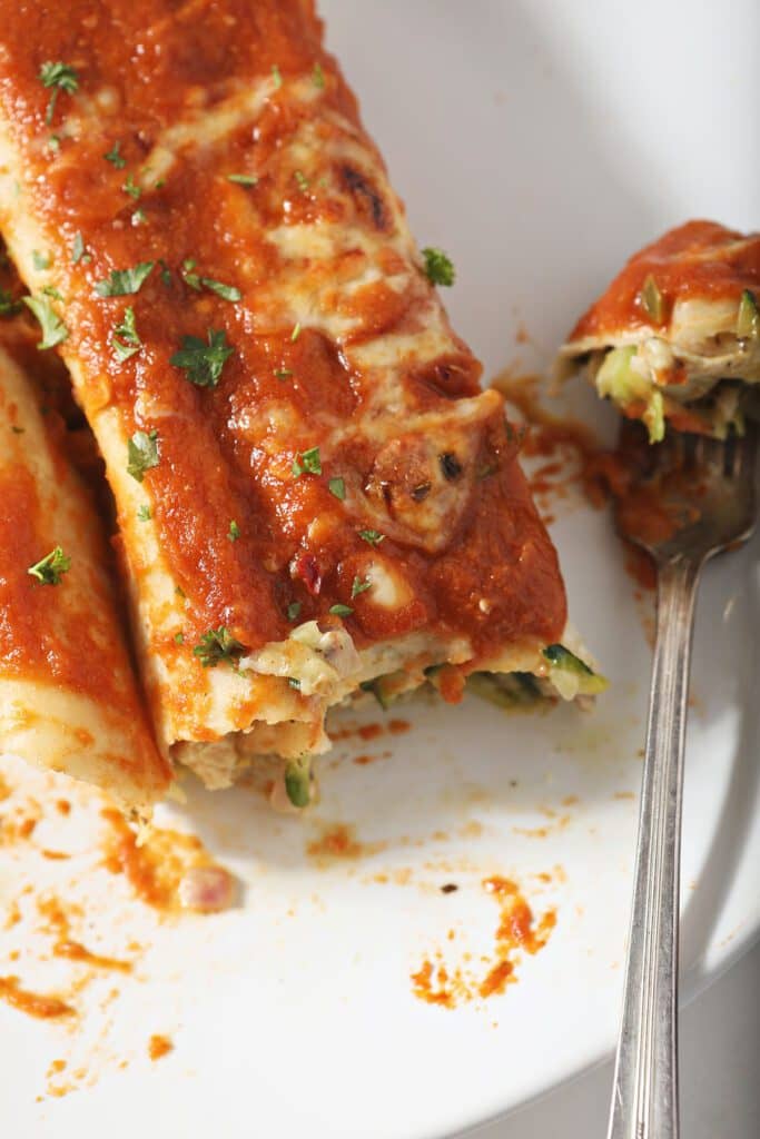 chicken zucchini enchiladas on a plate with a fork