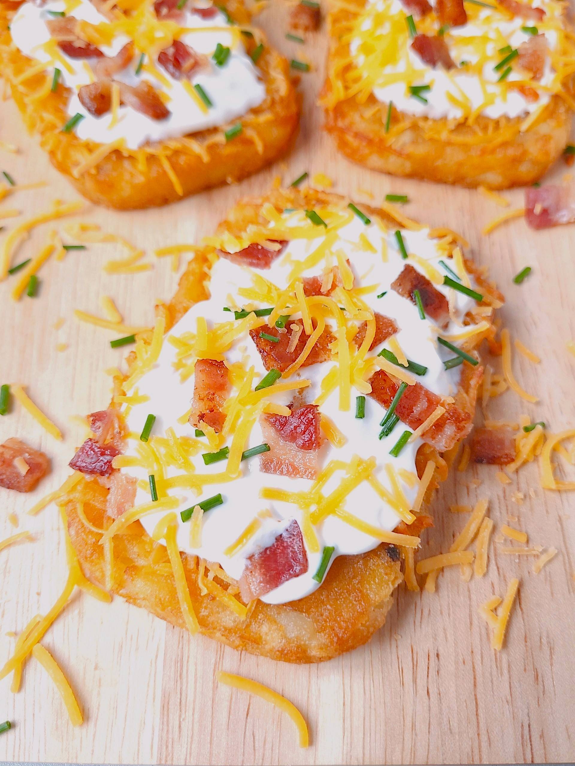 Loaded hash brown patty with sour cream, bacon, cheese and chives.