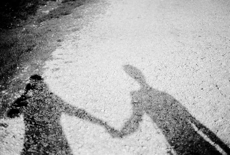 A shadow of a man and a woman holding hands