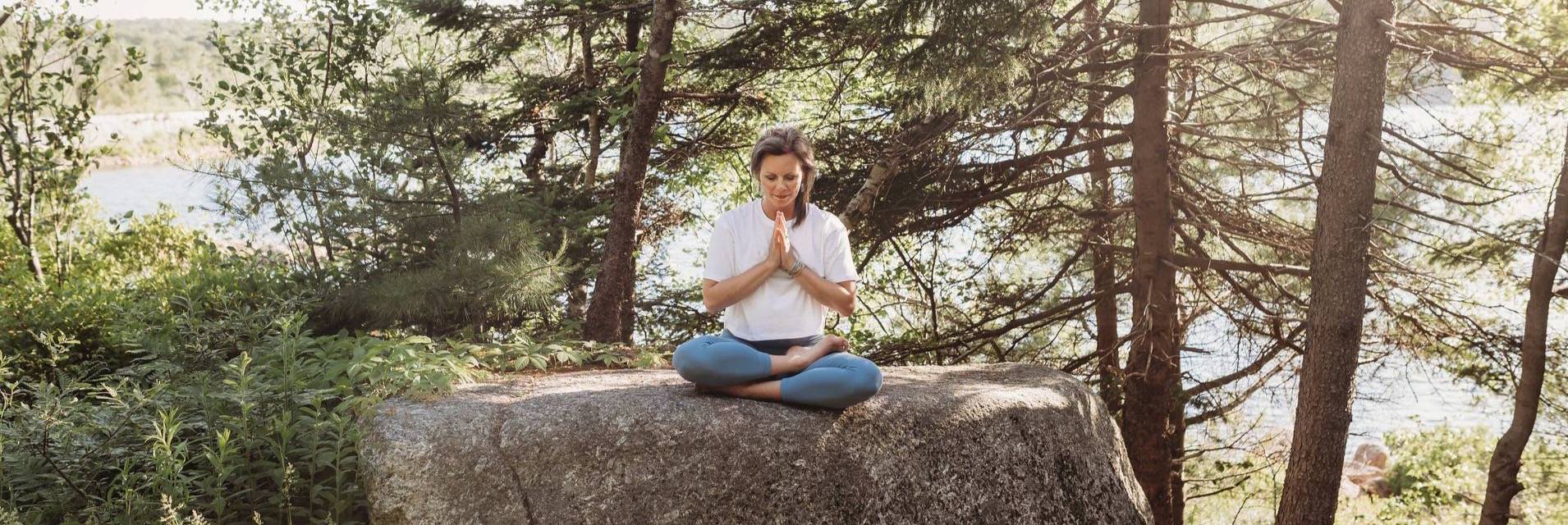 Michelle Hicks-Robinson seated in nature for meditation