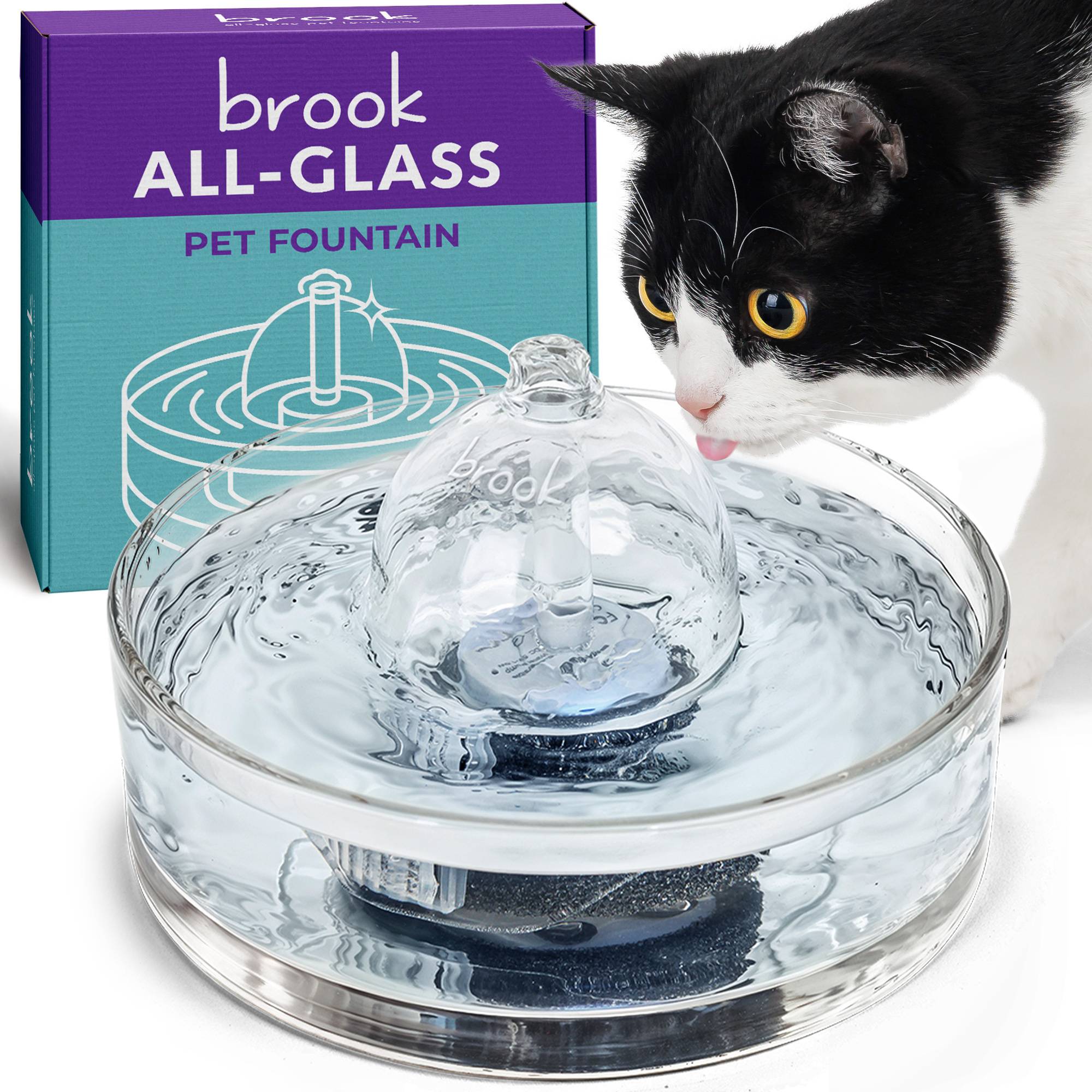 A white and lack cat drinking from the Brook Glass Cat Fountain