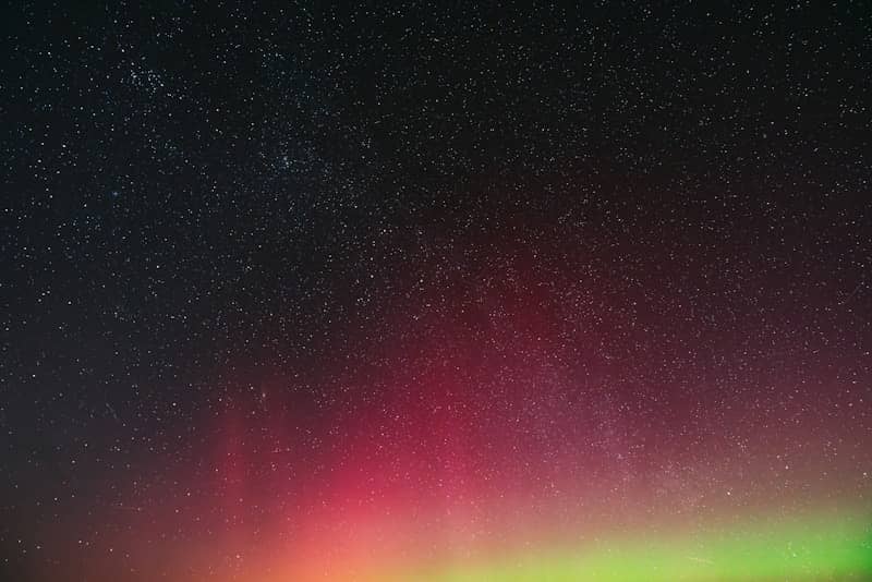 Beautiful aurora borealis dances across a starry night sky.