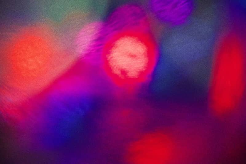 A blurry image of a red and purple light