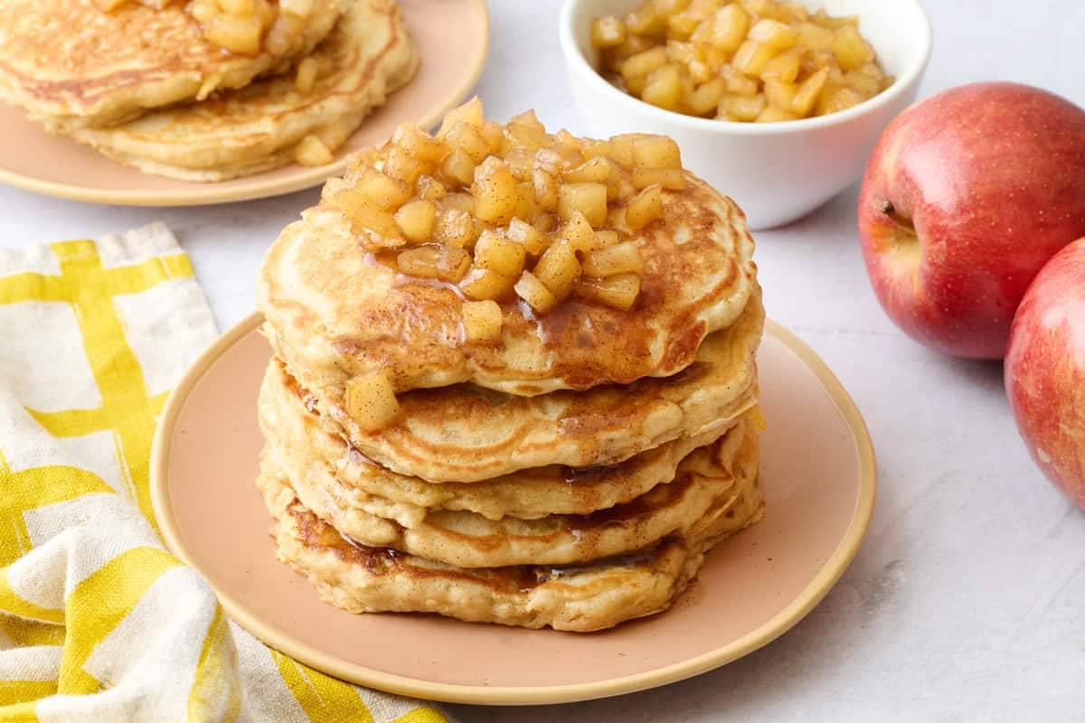 Stack of homemade apple pancakes topped with apple compote.