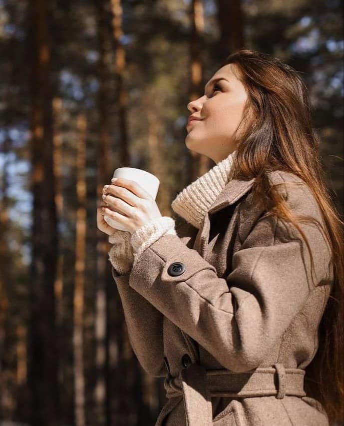 Hand holding a bouquet of yellow mimosa flowers