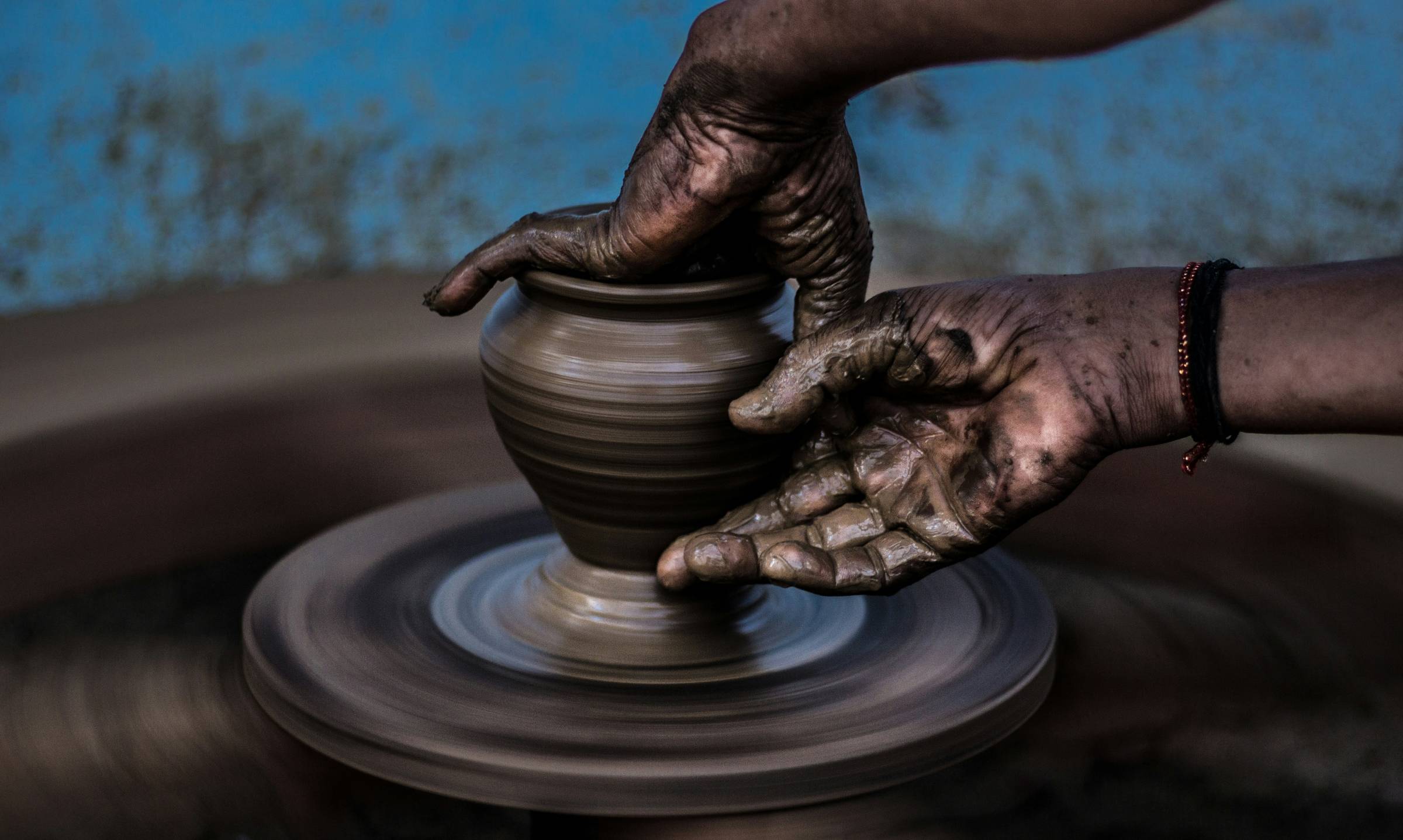 Image of hands creating pottery