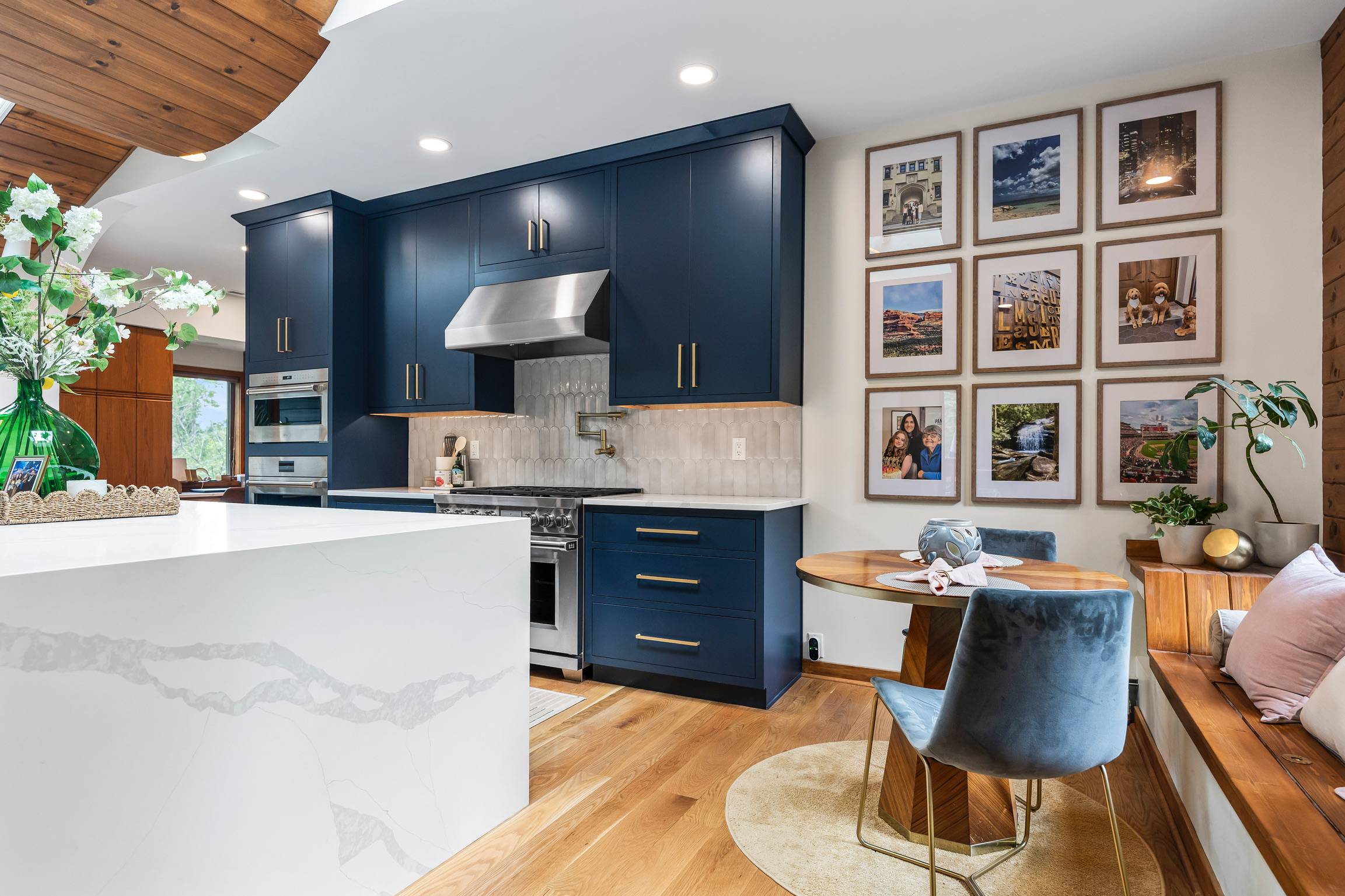Two picnic tables on a grassy hill overlooking the ocean.