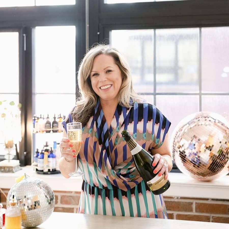 Kristin holding a glass of champagne