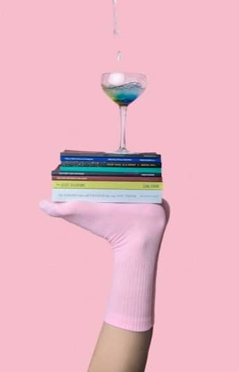 Balancing books and a glass of drinks on fee