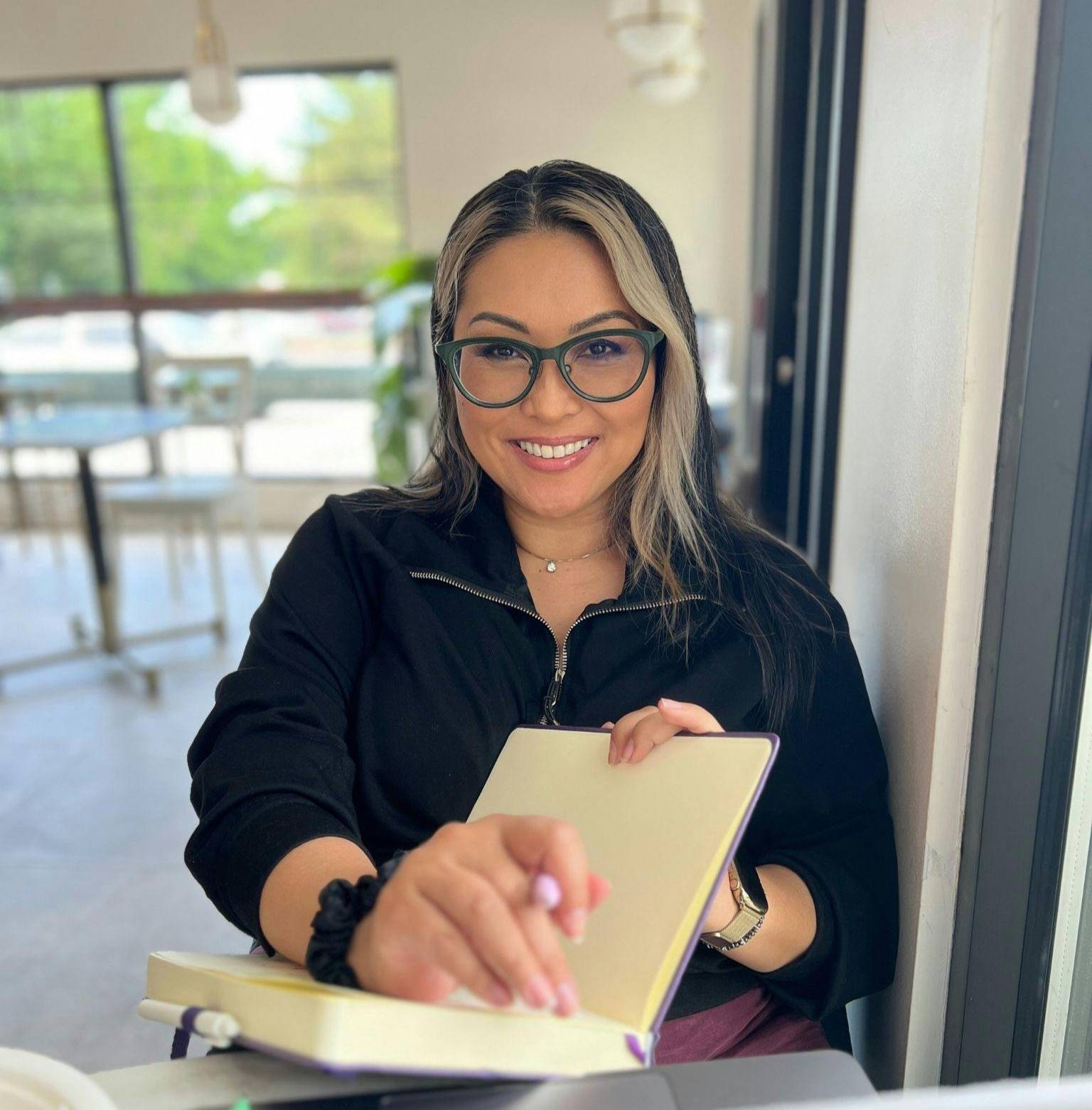 Cheryl Marquez journaling in a coffee shop