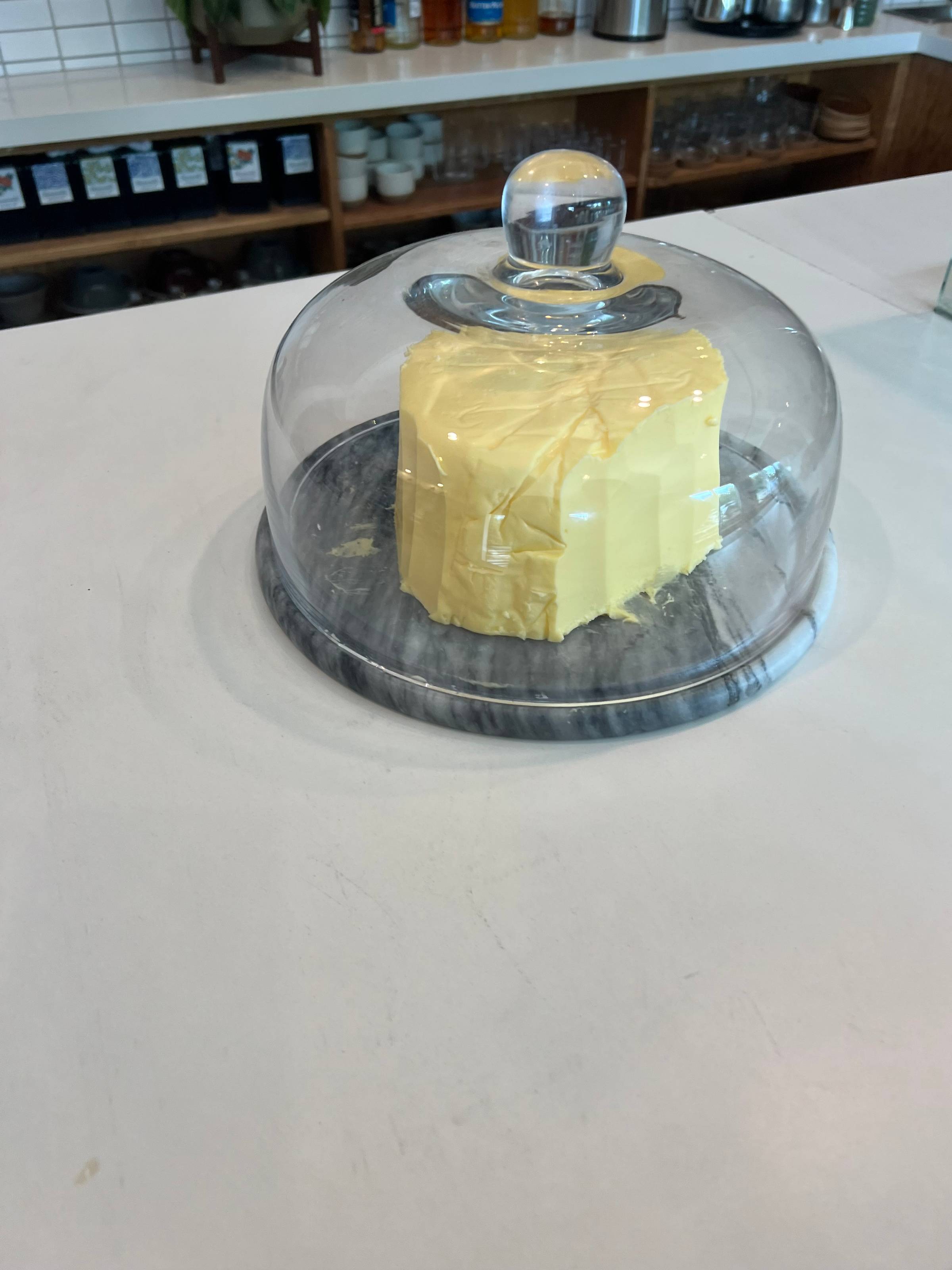 large slab of butter in glass cloche 