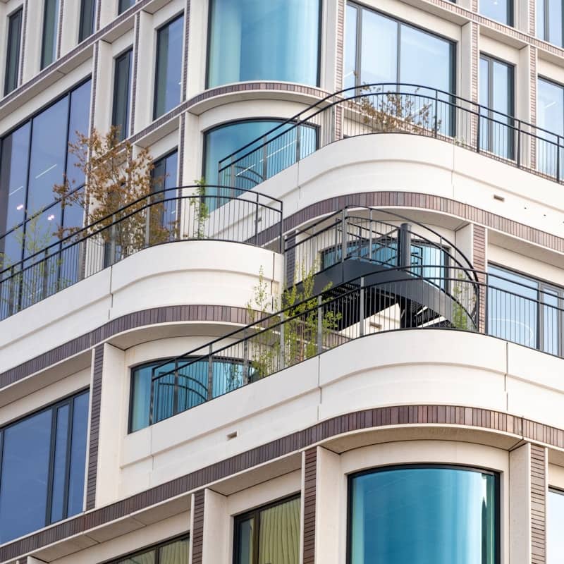 Modern building with curved balconies and windows.