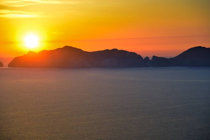 Sunset illuminates the sea and islands.