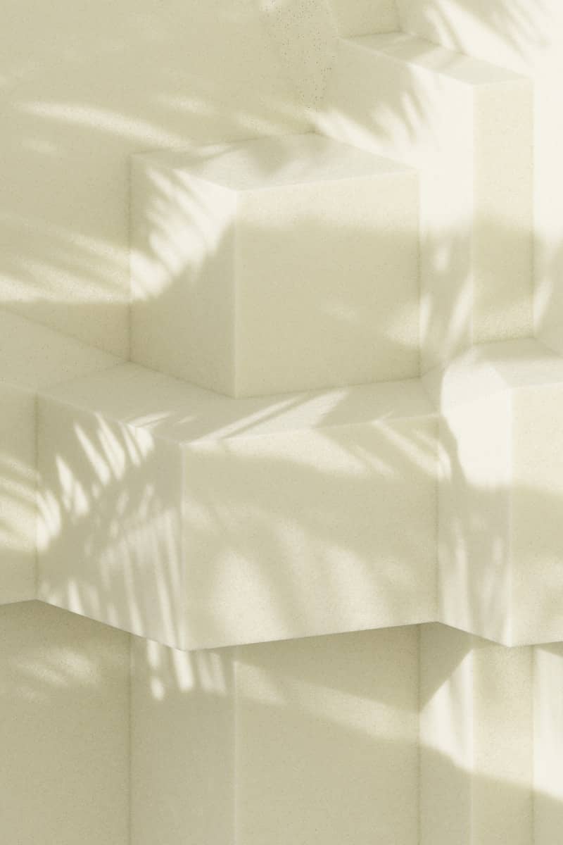 Geometric blocks with palm tree shadow.