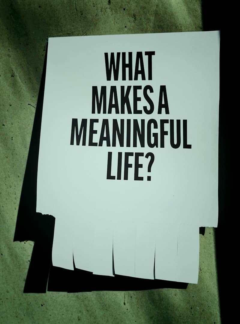 A paper with "what makes a meaningful life?" text.