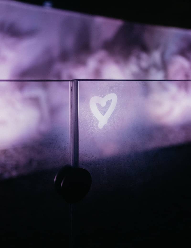 A white heart drawn on frosted glass