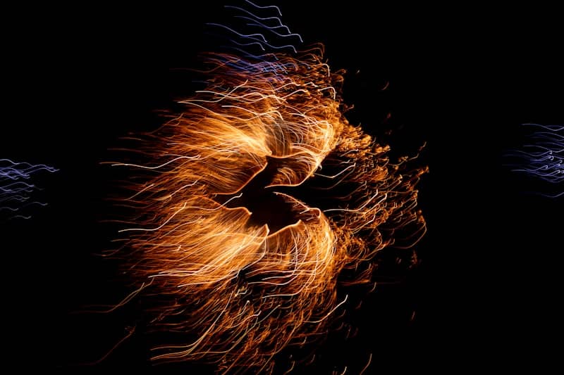 Vibrant fireworks burst against a black sky.