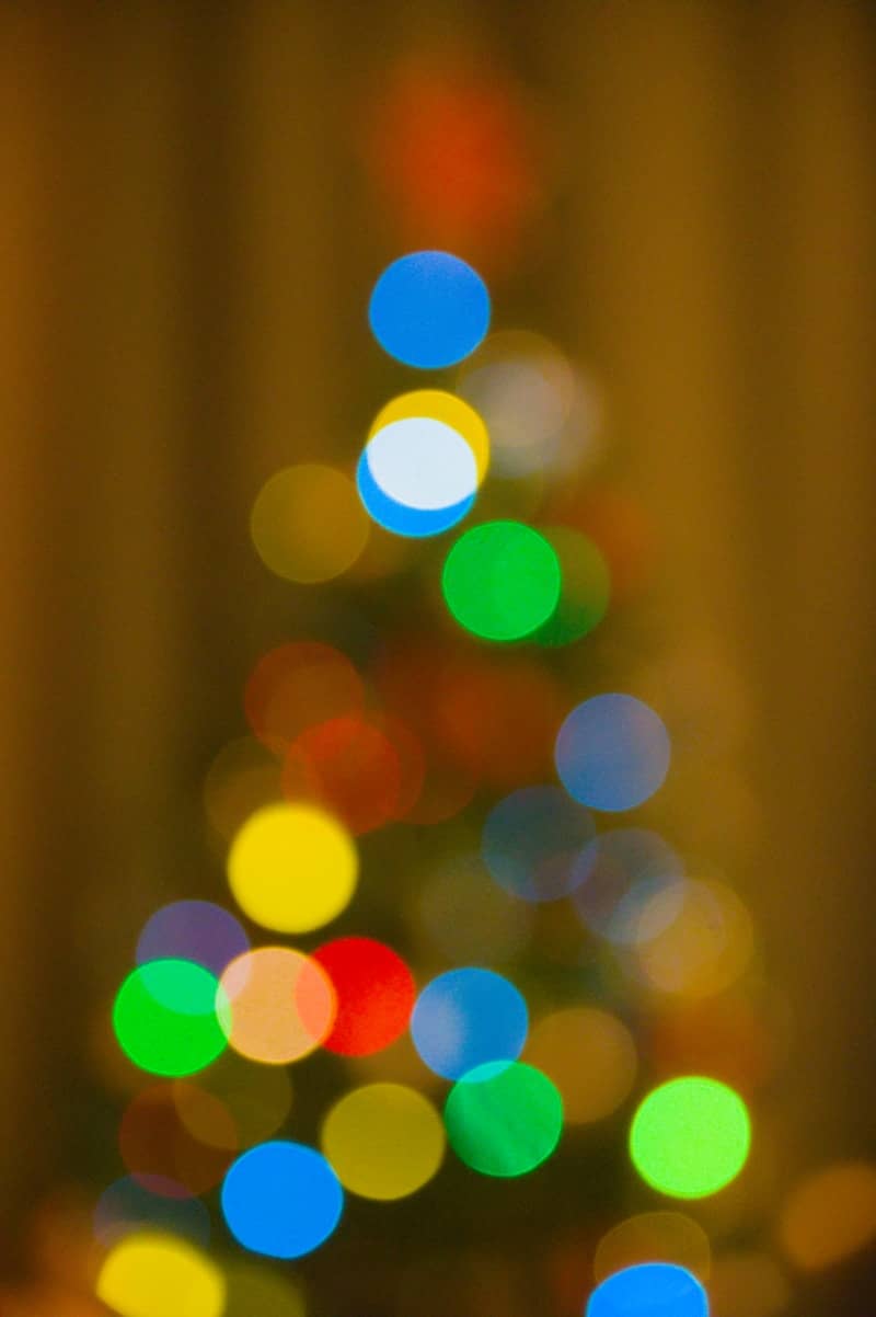 Blurred colorful christmas tree lights on dark background