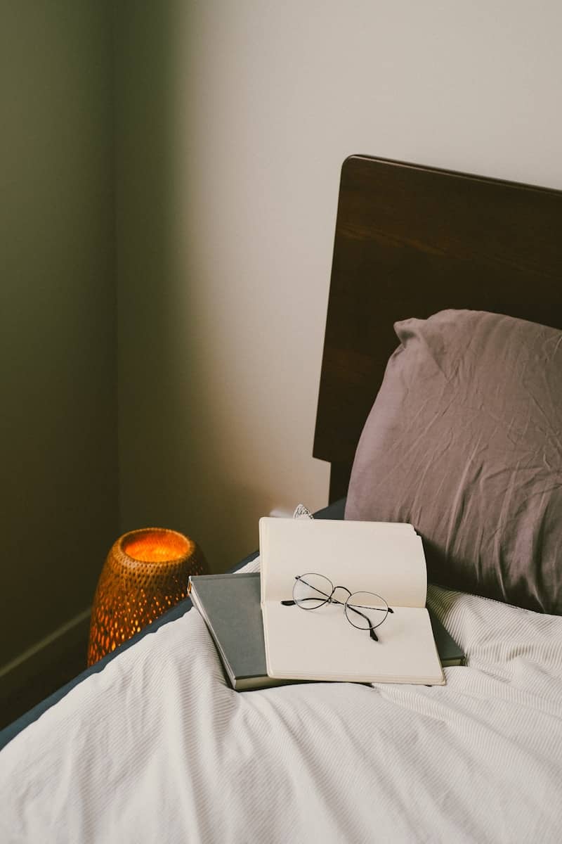 A bedside reading setup with cozy lighting.