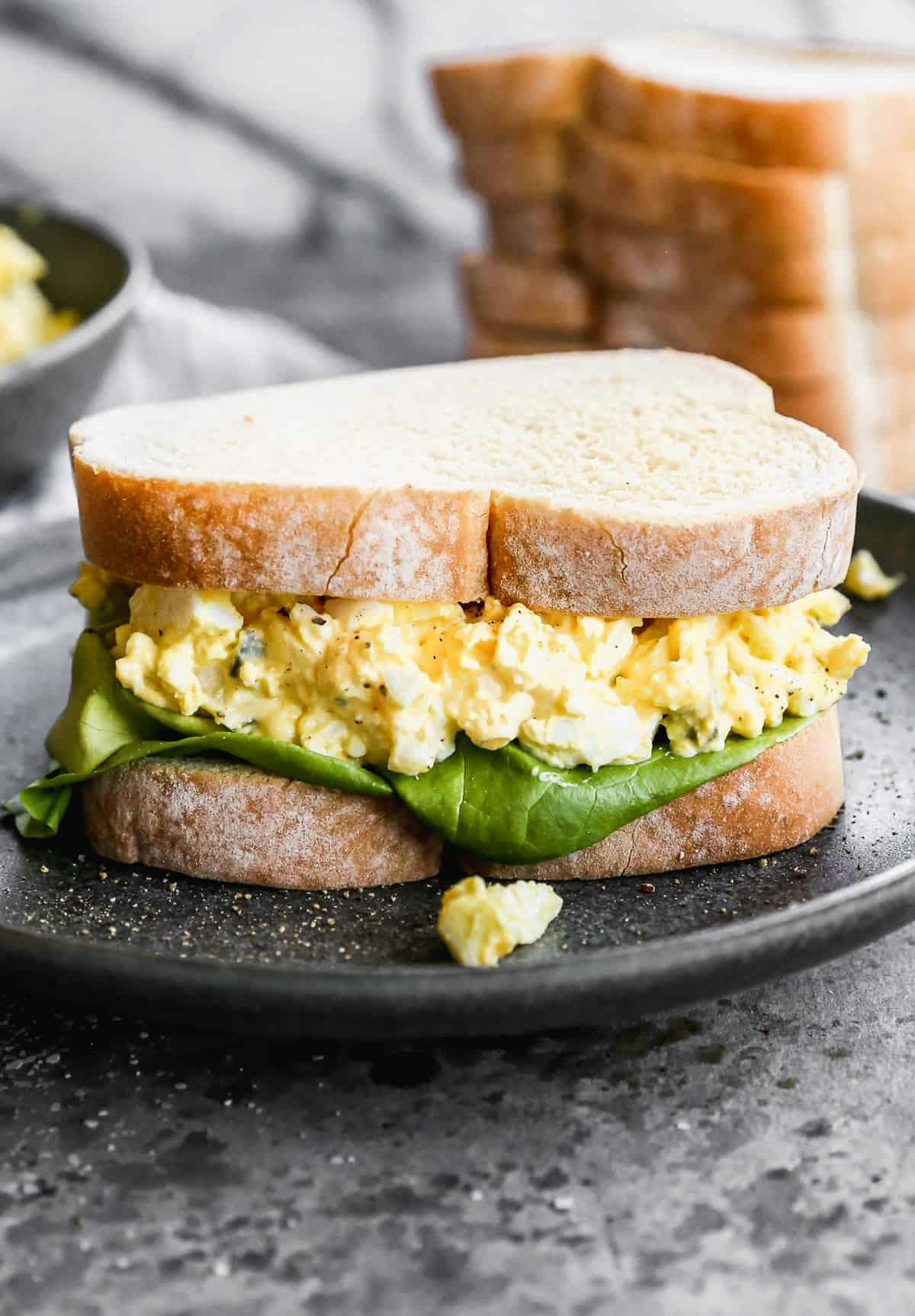 Egg Salad Sandwich served on a black plate