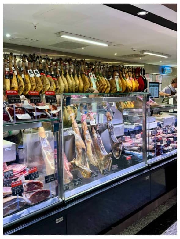 Lauren holding a whole chicken, next to a photo of a meat shop in Barcelona.