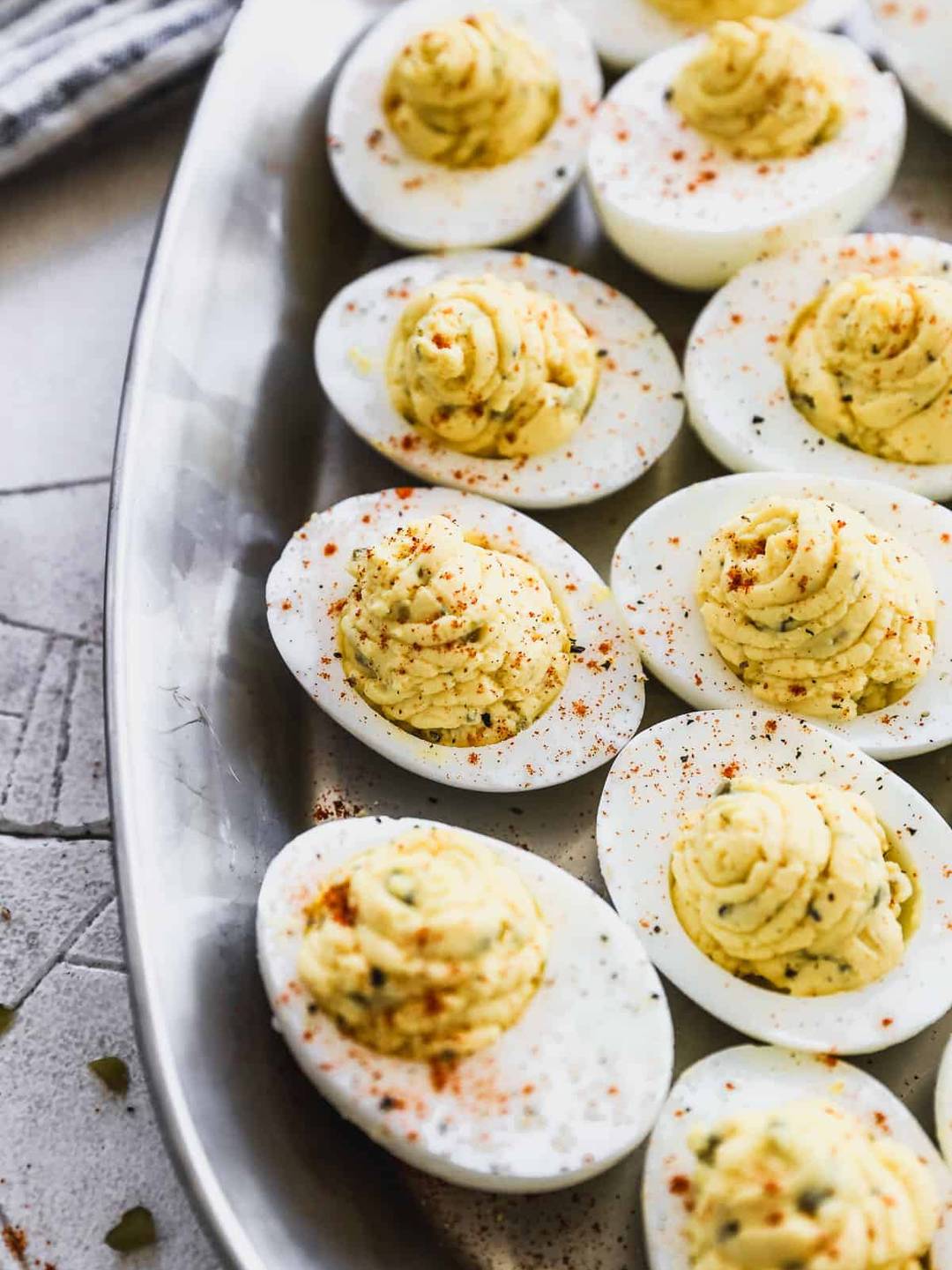 Deviled Eggs served on a silver plate.