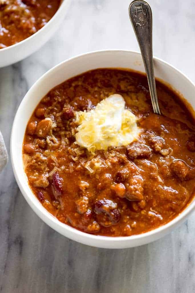 Classic Homemade chili topped with sour cream and a sprinkling of cheese