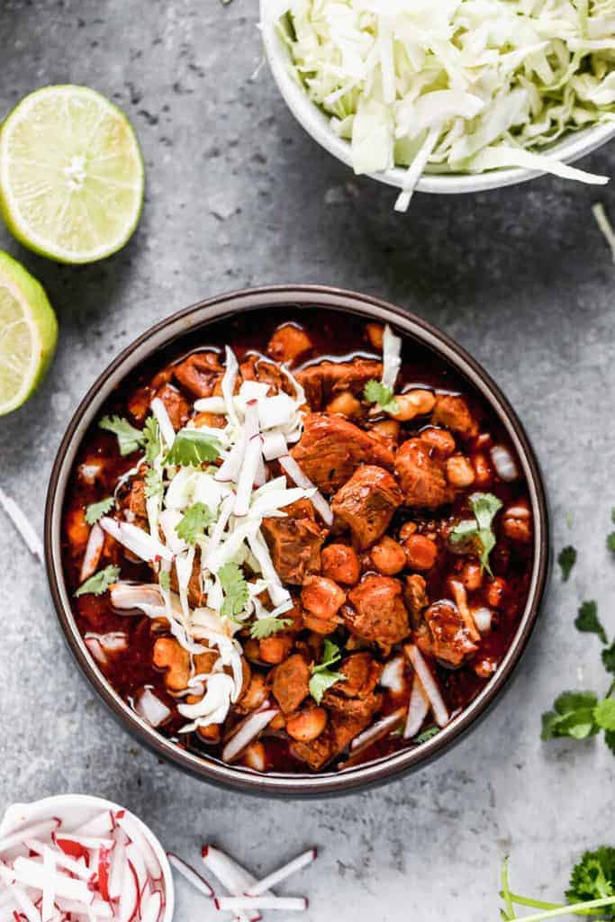 Pozole garnished with shredded cabbage and thinly sliced radishes. 