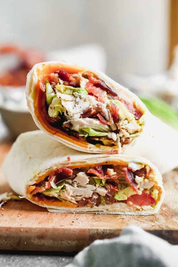 Turkey Club Wraps filled with turkey (or rotisserie chicken), bacon, lettuce, tomato, cheese and avocado.