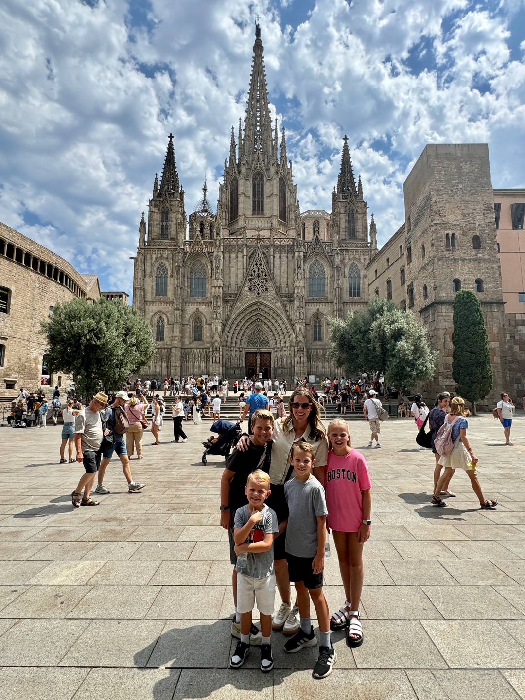 Lauren and her children in front of the Cathedral of Barcelona.