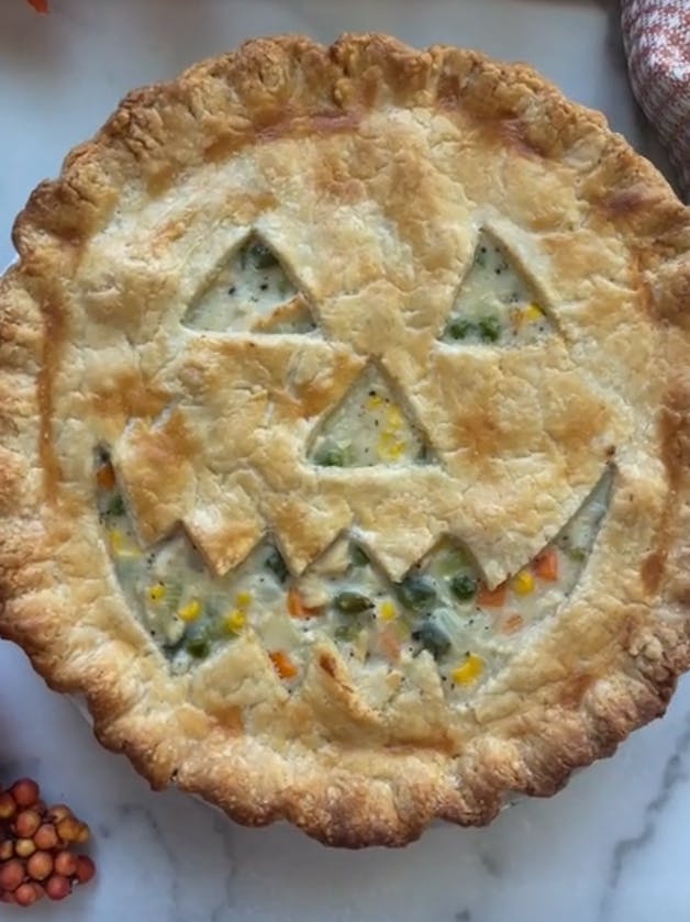 Pumpkin face cut out of chicken pot pie.