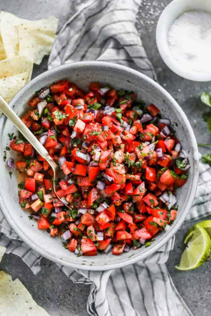 Pico de Gallo served with fresh cilantro in a grey bowl