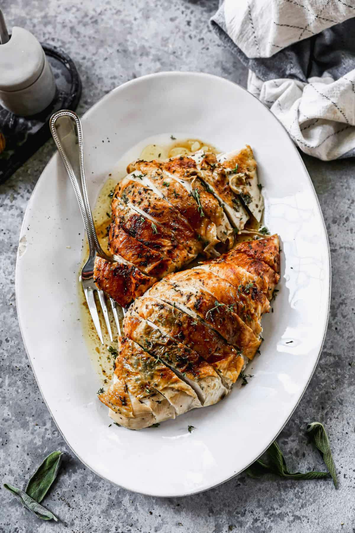 Roasted Turkey Breast served on a white platter 