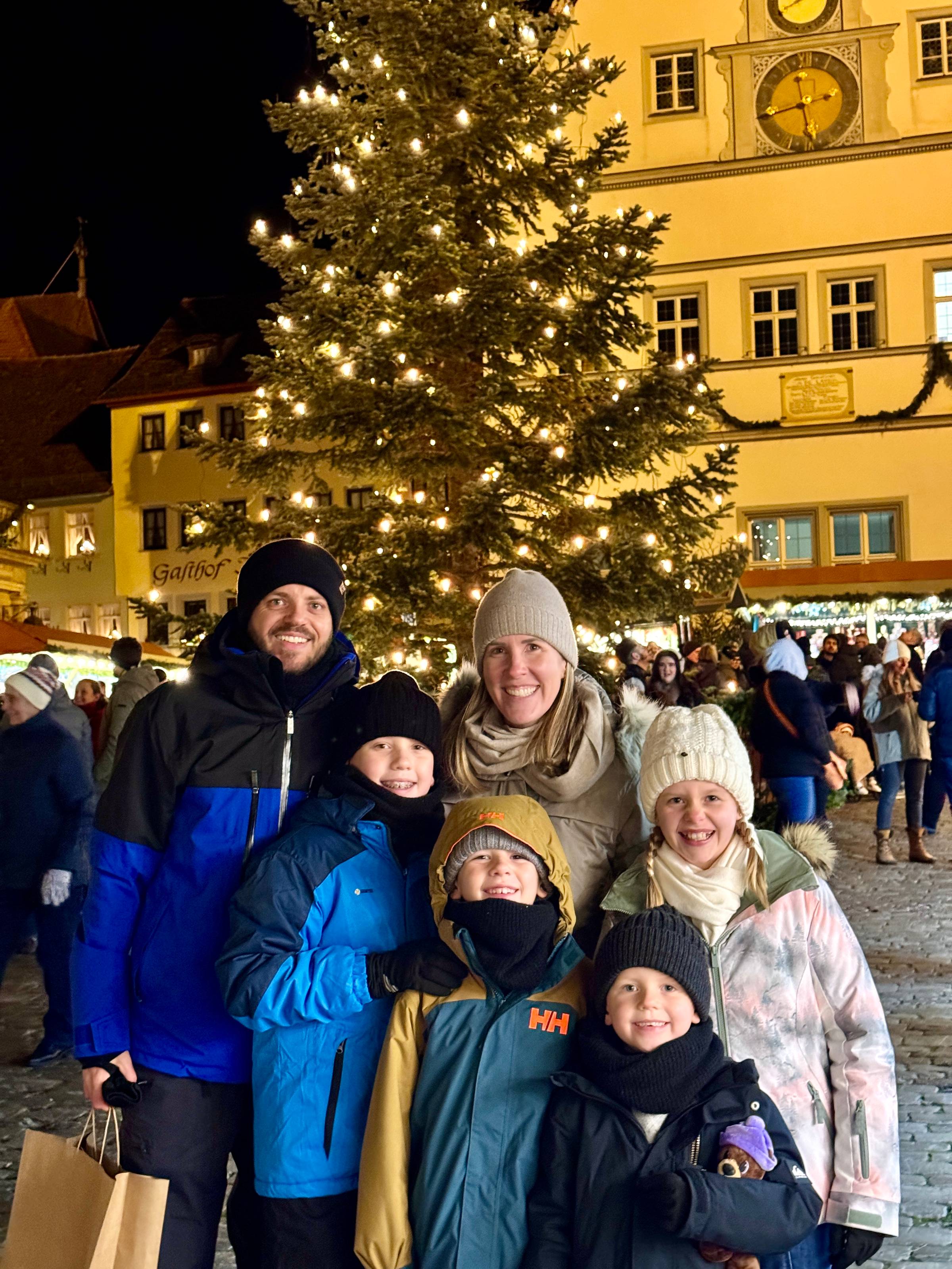 The Allen family in Germany for Christmas, standing in front of a Christmas tree.