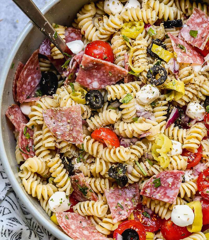 Italian Pasta Salad with a spoon in it, all in a large grey bowl.