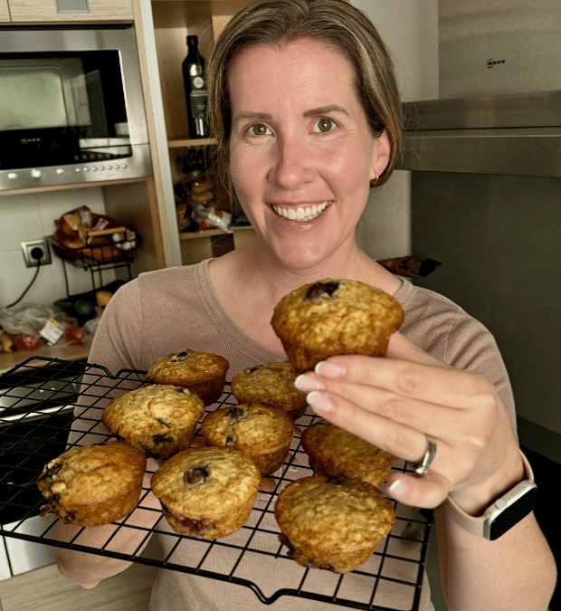 Lauren holding healthy muffins early release recipe.