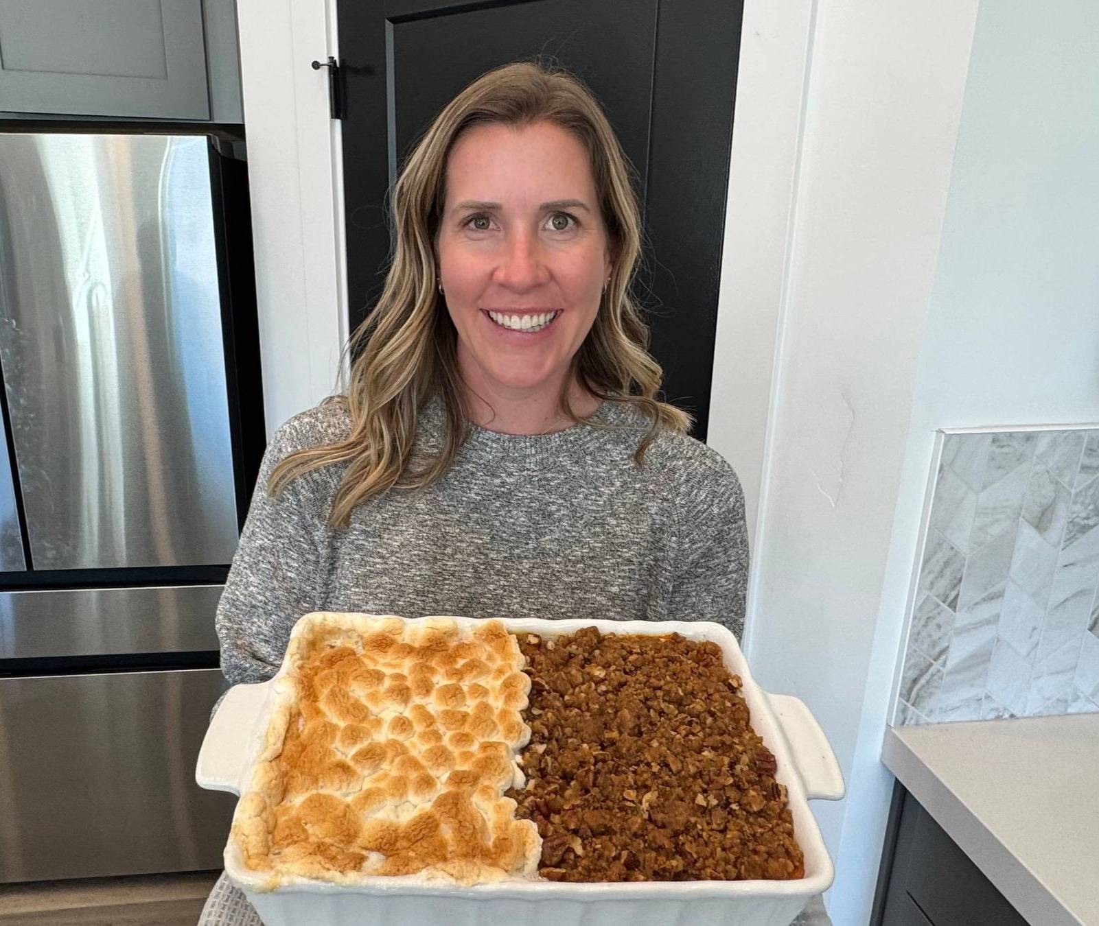 lauren with sweet potato casserole with two toppings- marshmallow and brown sugar pecan crumble.