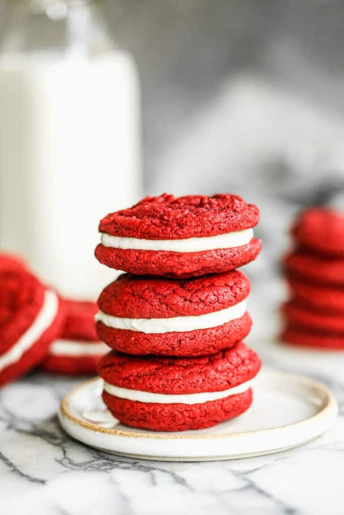 Red Velvet Cookies stacked on a small white plate