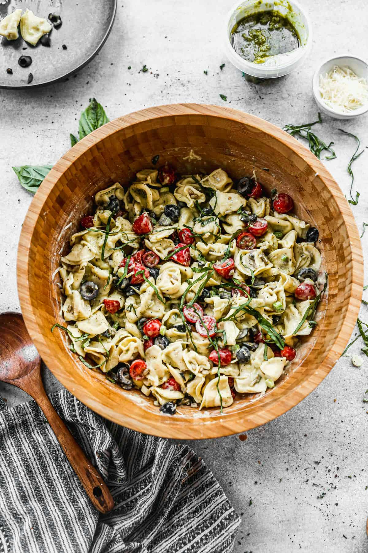 Pesto Tortellini served in a large wood bowl.