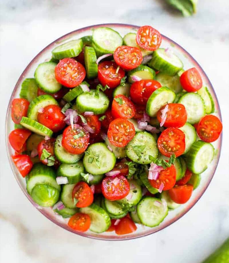 Tomato Cucumber Salad served in a clear bowl.