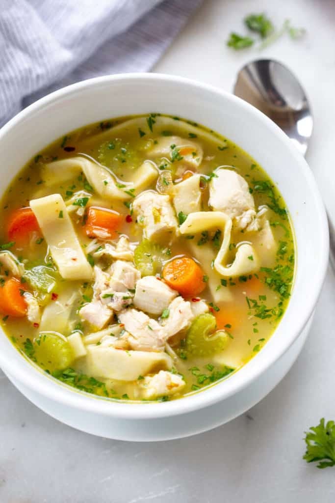 Chicken noodle soup in a white bowl