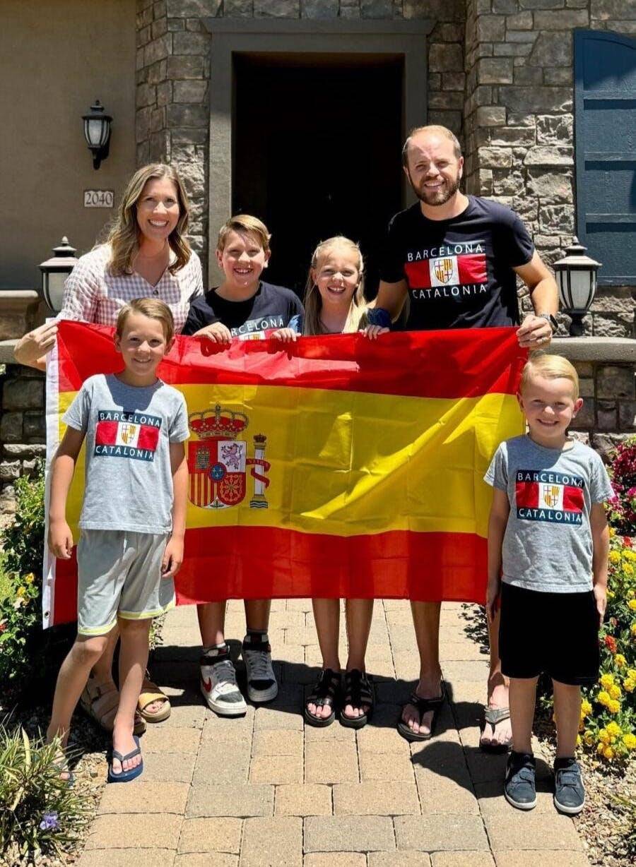 Lauren and family holding a Spanish flag.