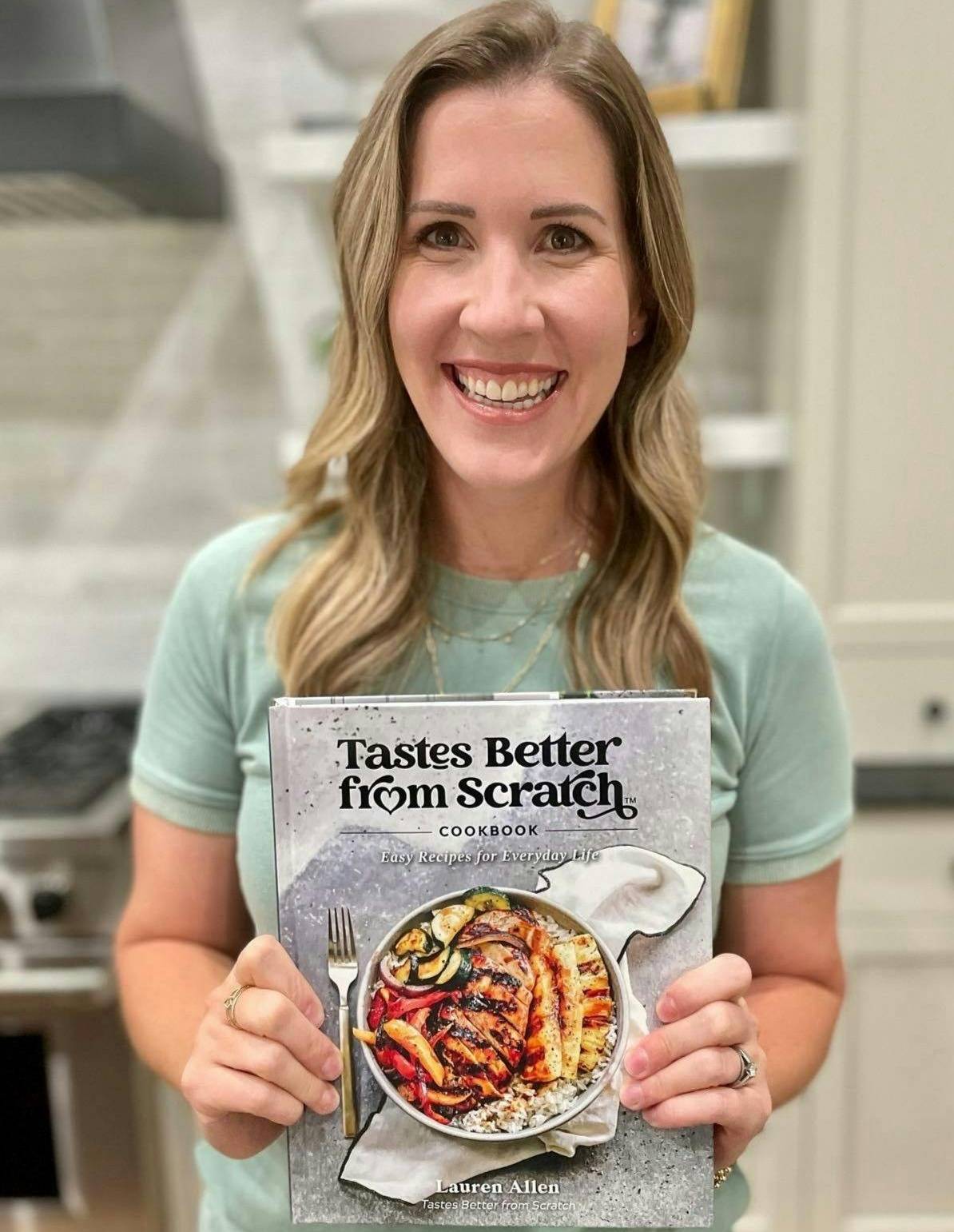 Lauren holding our cookbook.