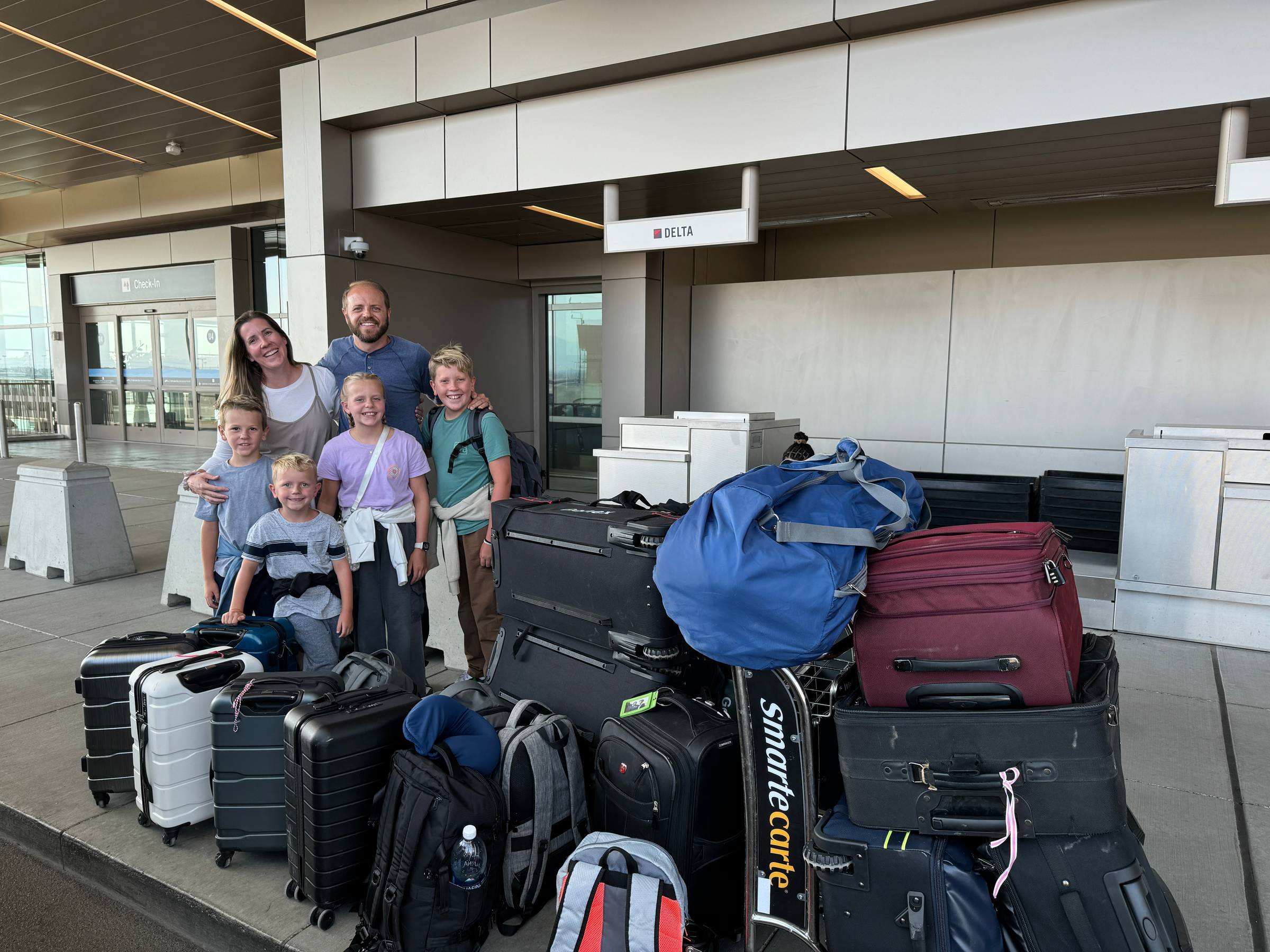 Lauren, Jeff, and the kids at the airport with all of their luggage!