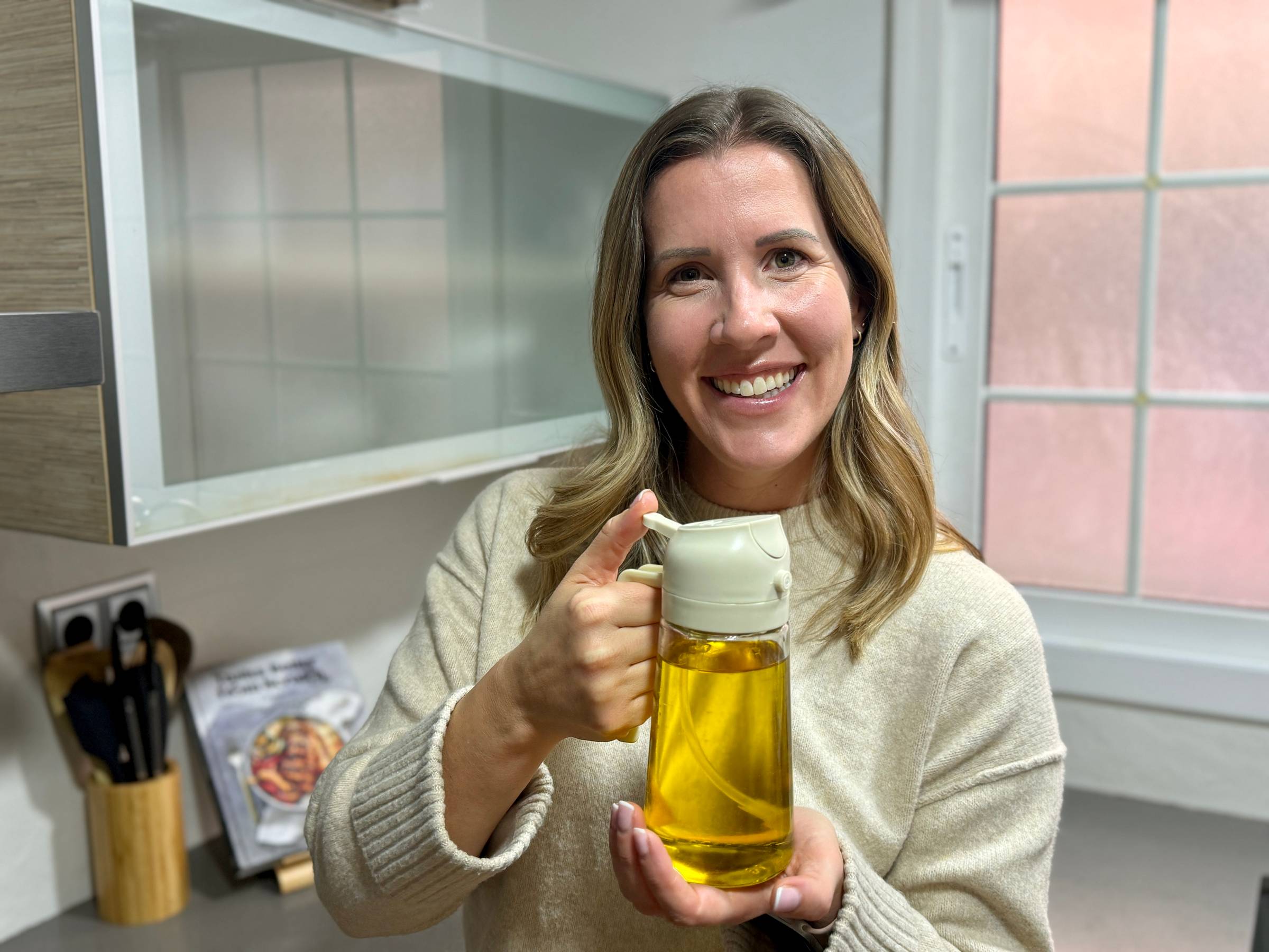 Lauren holding olive oil sprayer.