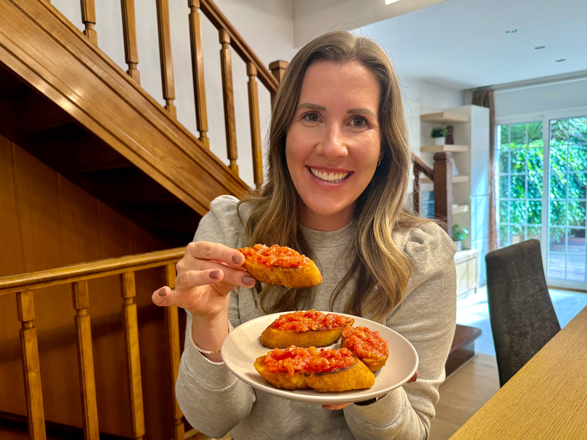 Lauren holding a photo of pan con tomate.