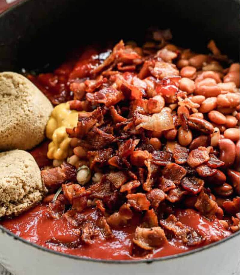 Baked Beans topped with bacon and served with bread rolls. 