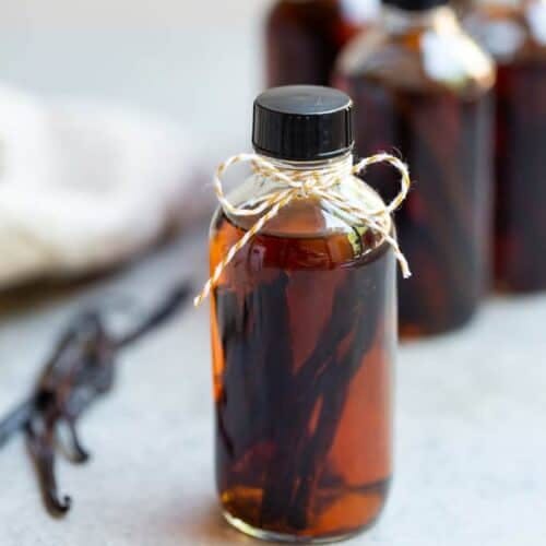 Homemade Vanilla in a glass jar with a bow tied at the top