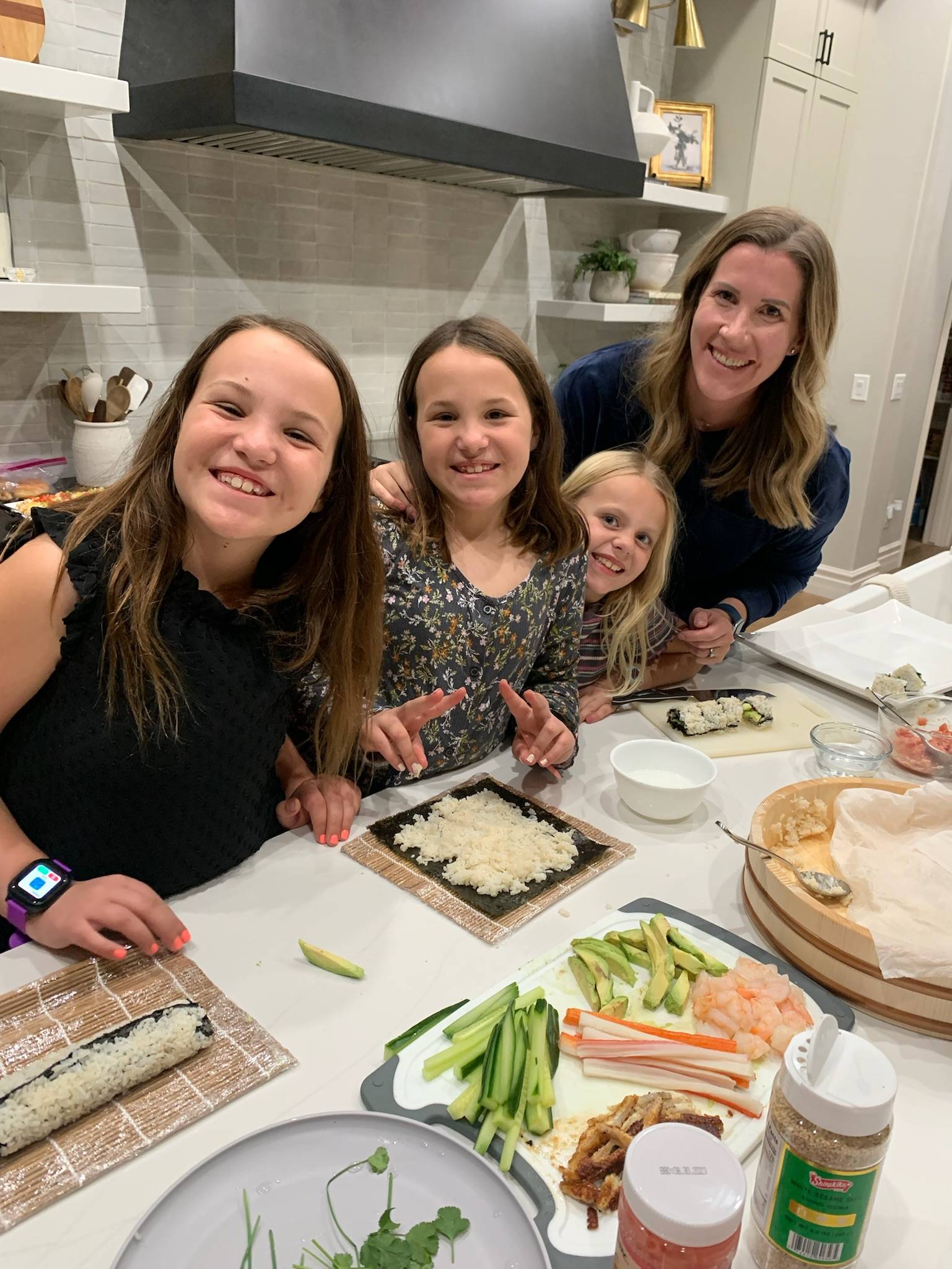 Lauren, her daughter, and two nieces making sushi for New Years Eve