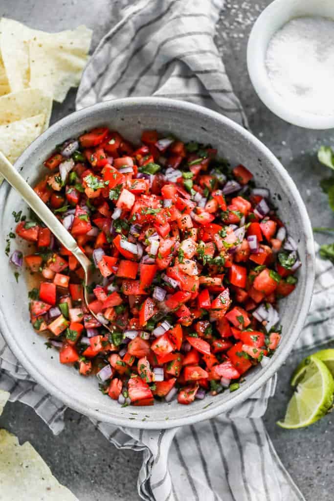 Pico de Gallo served in a grey bowl and garnished with fresh cilantro